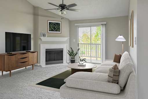 A living room with a white couch and a fireplace.