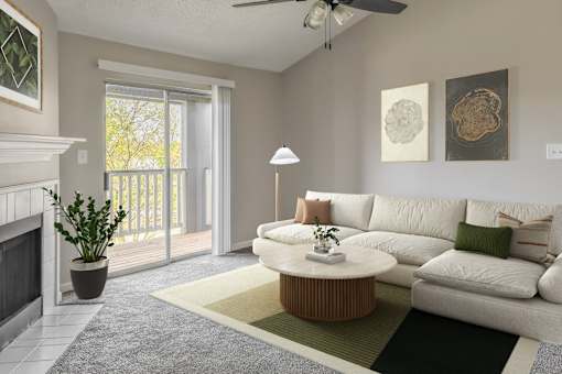 A living room with a white couch and a fireplace.
