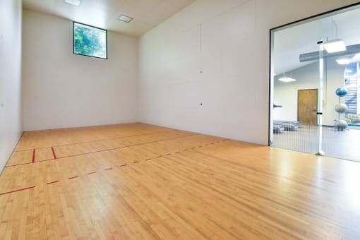 an empty room with a racquetball court  at Riverset Apartments, Tennessee