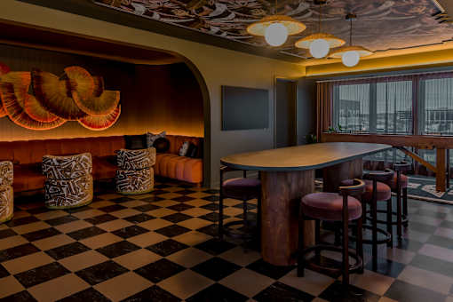 A black and white checkered floor in a room with a bar.