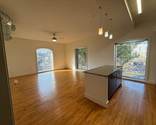 A room with wooden floors and a kitchen island.