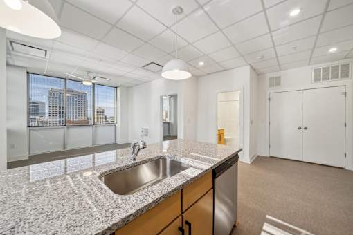 A kitchen with a granite countertop and stainless steel appliances.