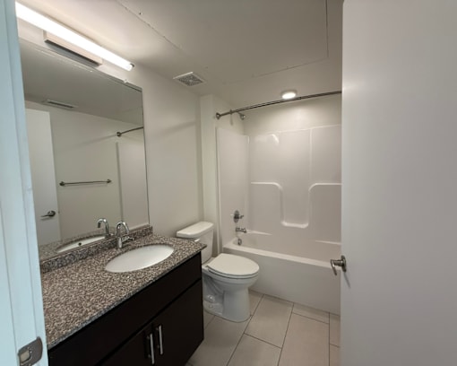 A bathroom with a sink, toilet, and bathtub.