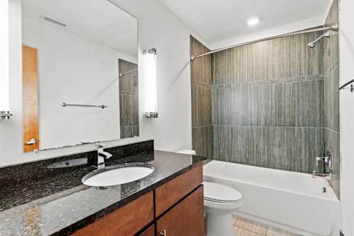 A bathroom with a sink, toilet, and bathtub.