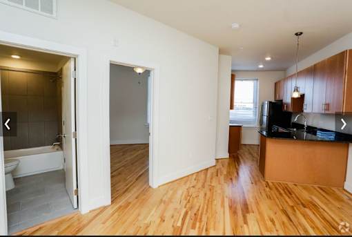 A room with wooden floors and white walls.