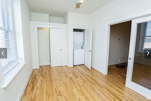 A room with wooden floors and white walls.
