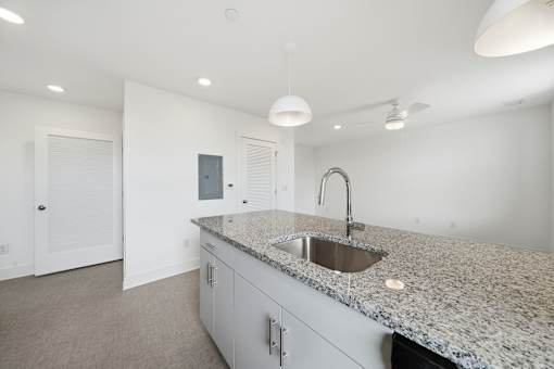 A kitchen with granite countertops and a sink.