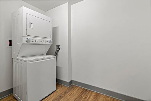 A white oven and fridge in a room with wooden flooring.