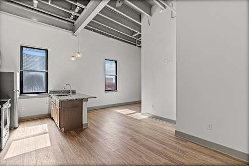 A kitchen with a wooden floor and a window.
