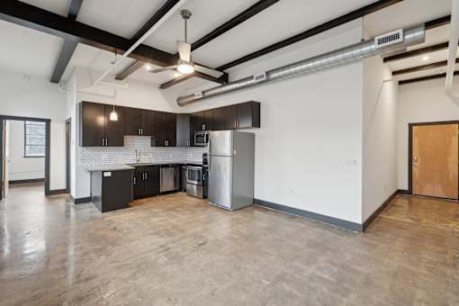 A kitchen with a refrigerator, stove, and oven.