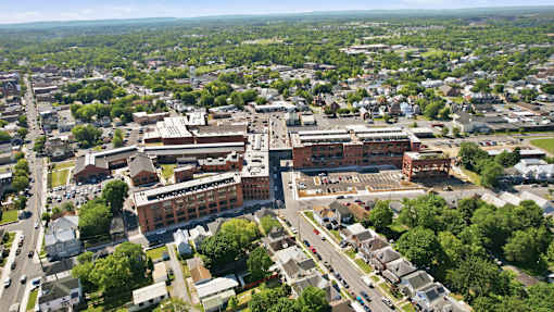 An aerial view of a town with a large building in the center.