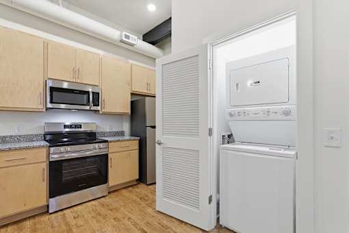 A kitchen with wooden cabinets and a white fridge.