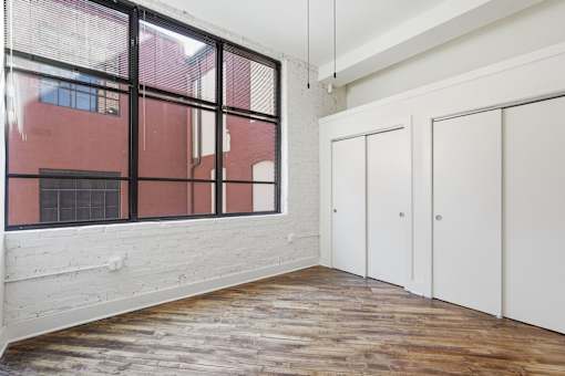 A room with a red wall outside the window and white walls inside.