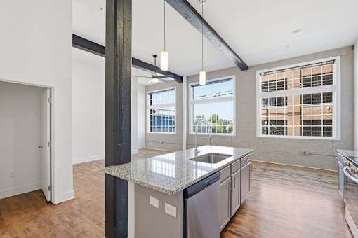 A kitchen with a large island and a view of the city.