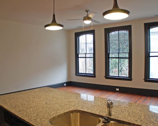 A kitchen with a granite countertop and a sink.