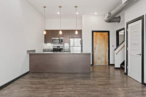 A modern kitchen with a wooden island and stainless steel appliances.