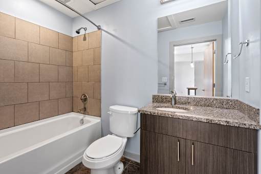 A bathroom with a toilet, sink, and bathtub.