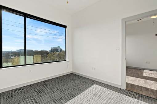 A room with a large window and a view of the outside.