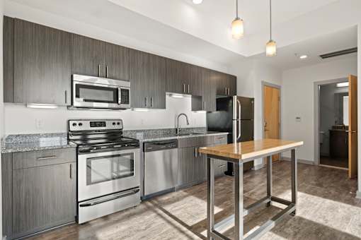 A modern kitchen with stainless steel appliances and wooden accents.