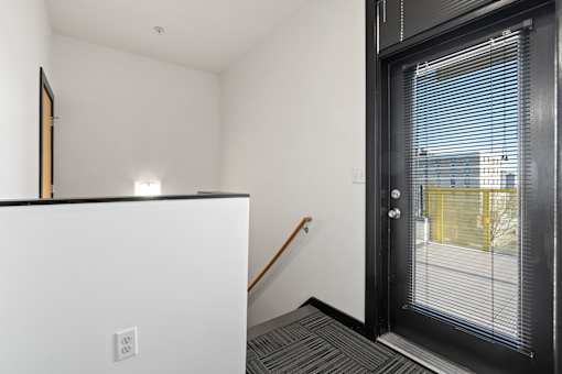 A black door with a window on the other side.