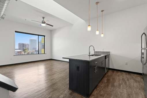 A modern kitchen with a large island and a view of the city.
