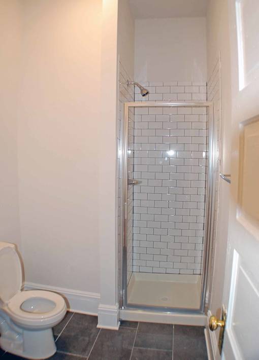 A white toilet in a bathroom with a glass shower door.