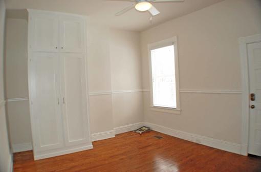 A room with a wooden floor and a window.