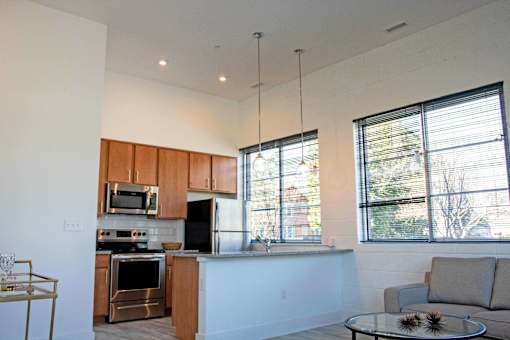 A modern kitchen with wooden cabinets and stainless steel appliances.