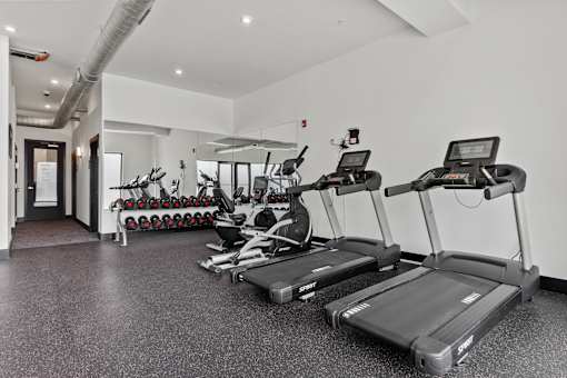 A gym with treadmills and exercise equipment.