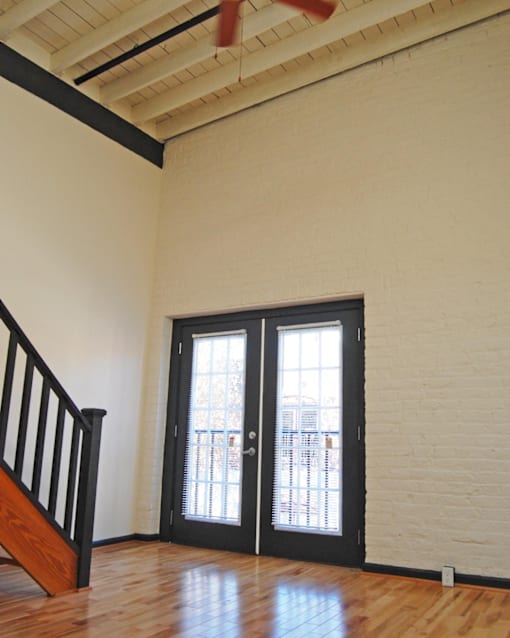 A room with a staircase and a door with a window.