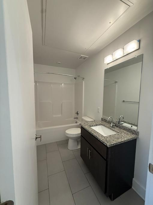 A bathroom with a sink, toilet, and bathtub.