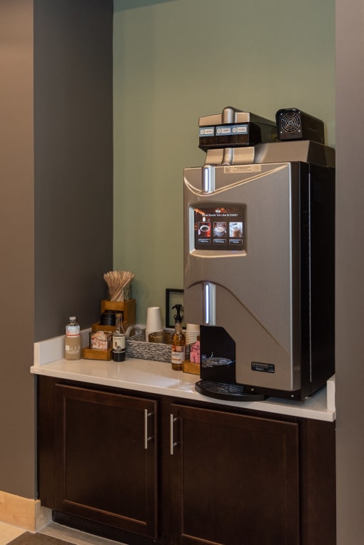a coffee maker on a counter in a hotel room at The Bend Arbordale, Williamsburg, VA, 23188