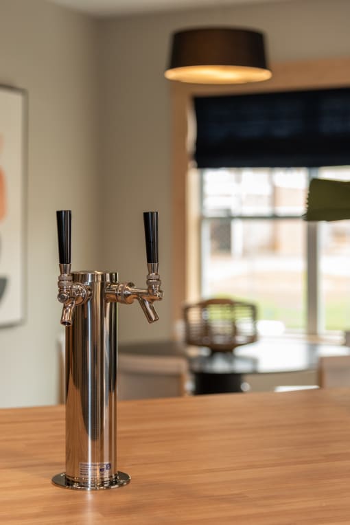 a close up of a table top with a wooden table and a window in the background at The Bend Arbordale, Williamsburg, Virginia