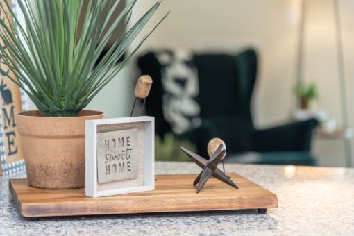 a wooden tray with a starfish and a picture on it on a counter next to a at The Bend Arbordale, Virginia, 23188