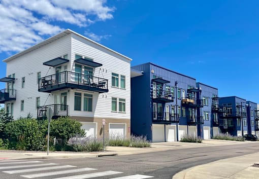 a row of apartment buildings on a city street at 8000 Uptown Apartments, Colorado