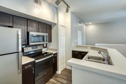 Kitchen with White Countertop at Rivertree Apartments, Riverview, FL