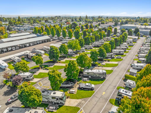 an aerial view of a parking lot filled with parked rvs