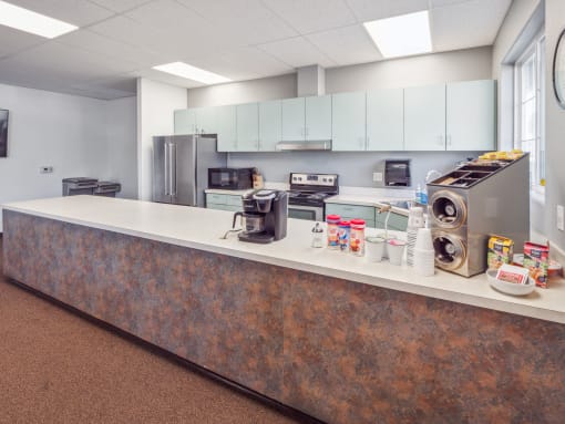 a kitchen with stainless steel appliances and a counter with a washing machine