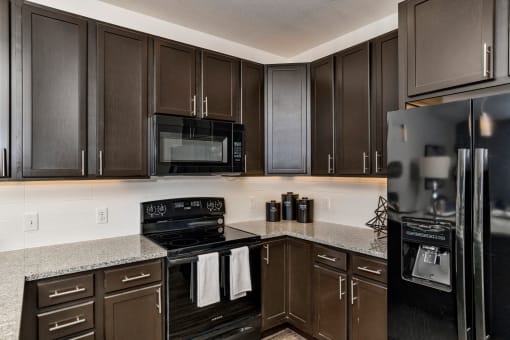 Kitchen With Black Appliances at West Line Flats Apartments in Lakewood, CO