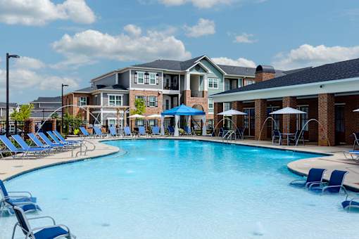 our apartments offer a large swimming pool with chairs and umbrellas at Annandale Apartment Homes, Murfreesboro, TN