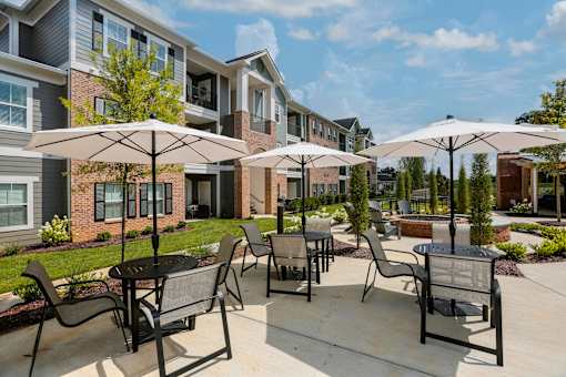 our apartments feature a patio with tables and chairs and umbrellas at Annandale Apartment Homes, Murfreesboro, Tennessee