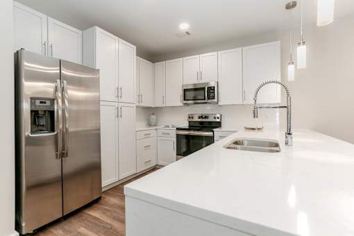 a white kitchen with stainless steel appliances and white counter tops at Annandale Apartment Homes, Murfreesboro, TN, 37128