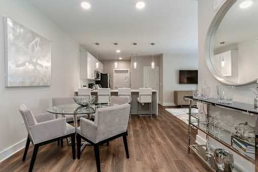 a living room and dining room with a glass table and chairs at Annandale Apartment Homes, Murfreesboro