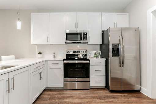 a white kitchen with stainless steel appliances and white cabinets at Annandale Apartment Homes, Murfreesboro, TN