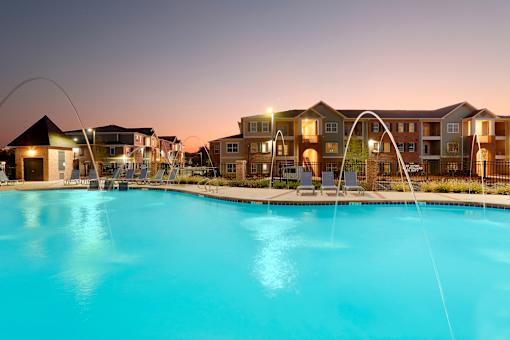 a large swimming pool with an apartment building in the background at Annandale Apartment Homes, Murfreesboro