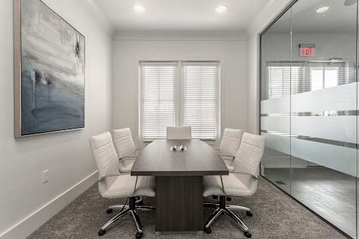 a conference room with a wooden table and white chairs at Annandale Apartment Homes, Murfreesboro