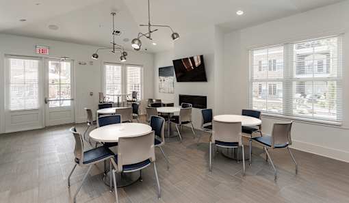 a dining room with tables and chairs and a fireplace at Annandale Apartment Homes, Tennessee 37128