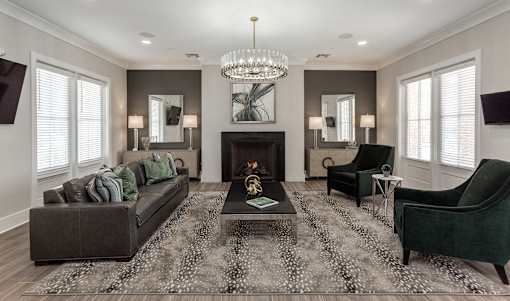a living room with a couch and chairs and a fireplace at Annandale Apartment Homes, Murfreesboro, 37128