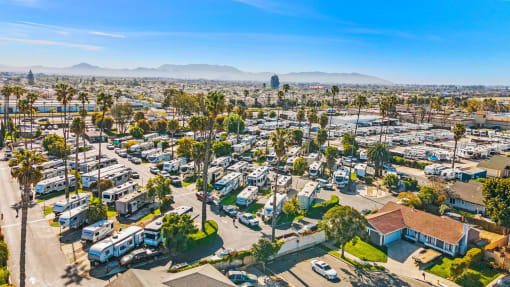 an aerial view of a parking lot filled with rvs
