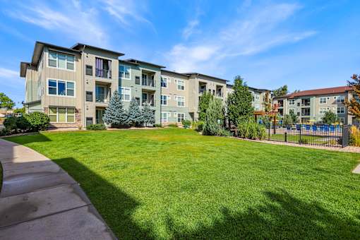 Apartment Complex with a Green Lawn at WestLink at Oak Station Apartments, Lakewood, CO, 80215